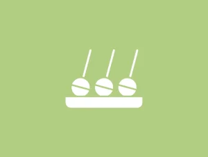 Three white skewers with coffee beans on a tray.